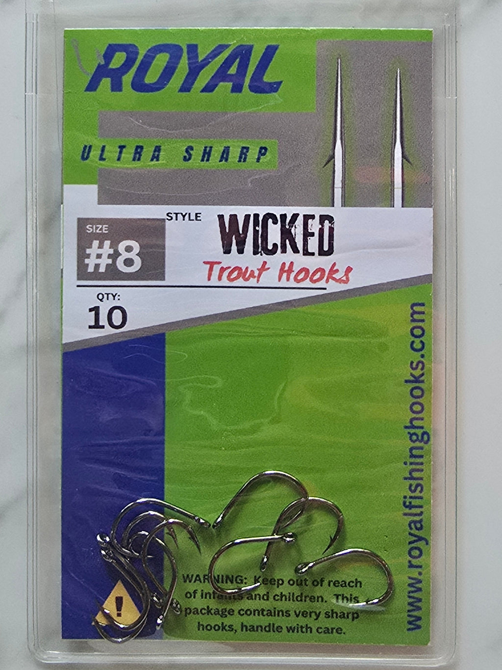 A pack of Royal Wicked Trout Hooks size #8, 10, in a clear plastic clamshell package with a green, white, and blue label, placed on a white marble surface.